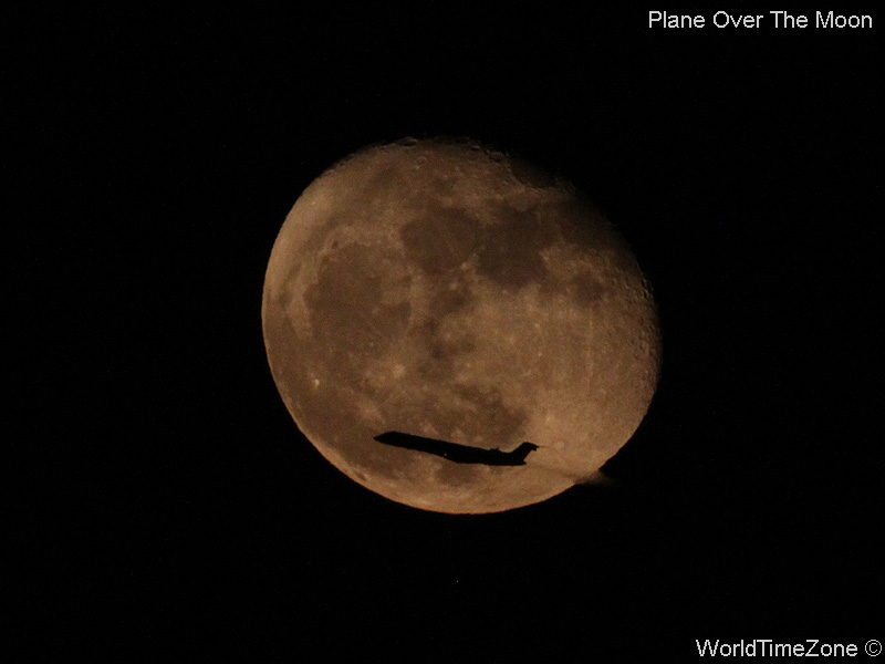 Plane over the Moon by worldtimezone