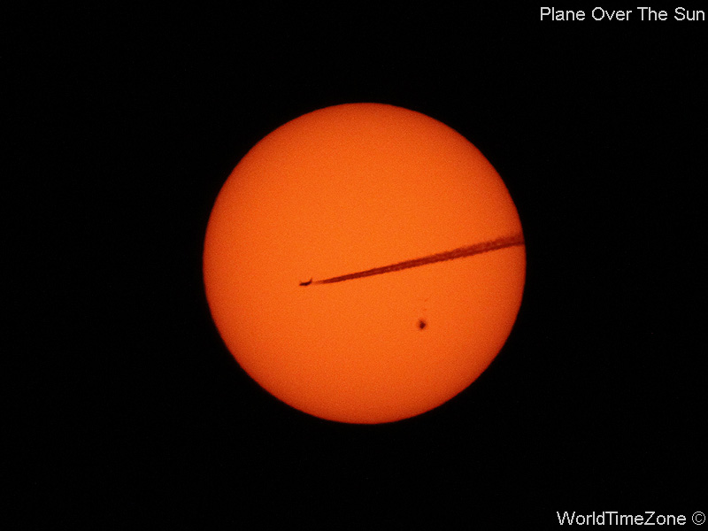 Plane over the Sun by worldtimezone